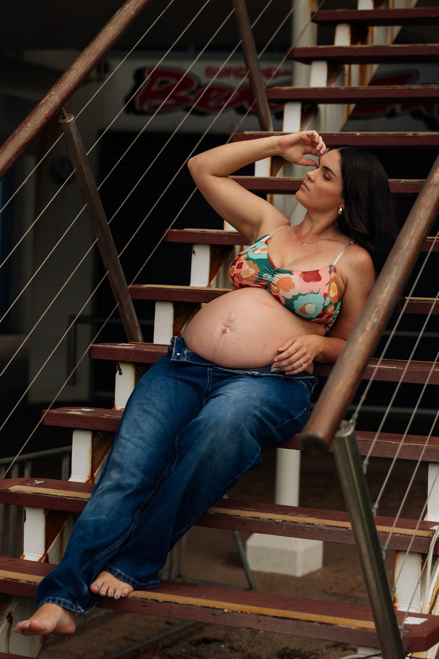 Maternity photography session at Mackay Surf Life Saving Club capturing expectant mother in bold editorial style