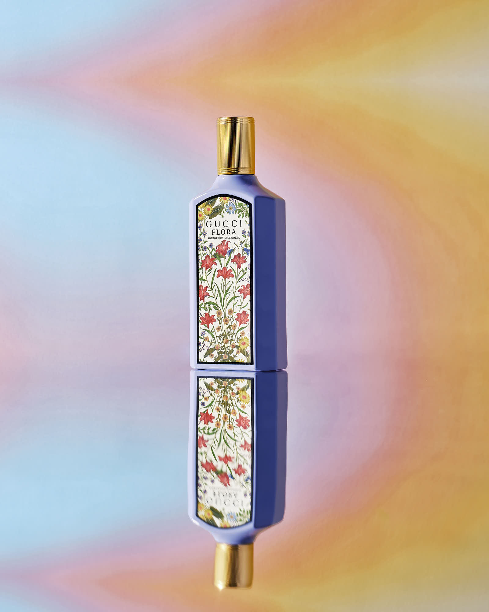 A colorful background features a gucci bottle with decorative patterns, emphasizing a playful and artistic vibe.