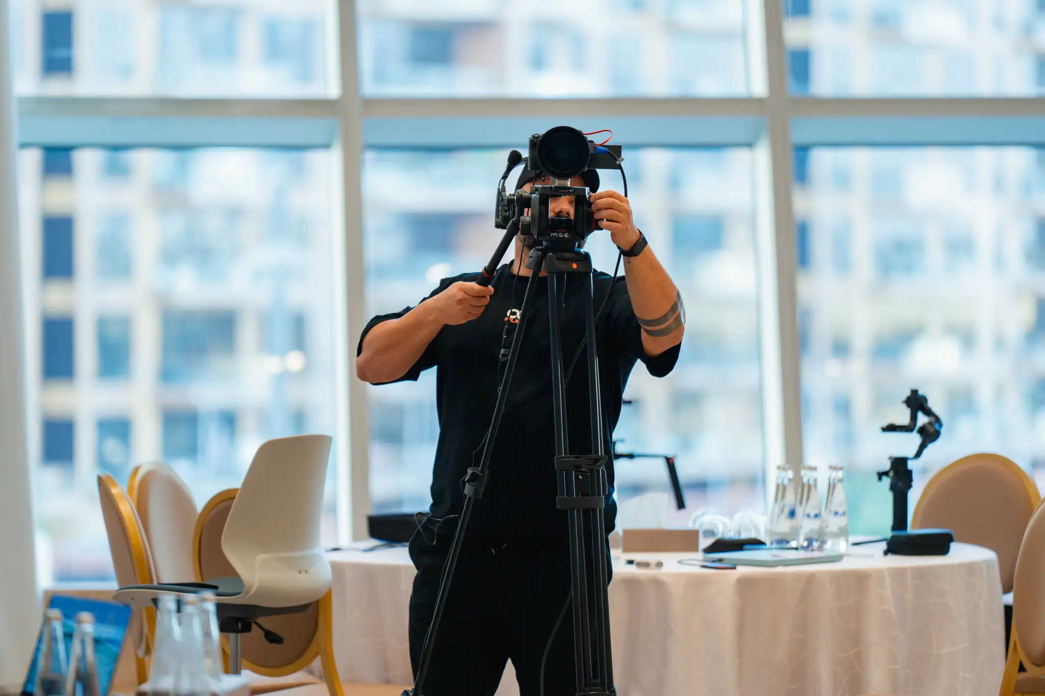 Portrait of a person in a pink sweater against a light background