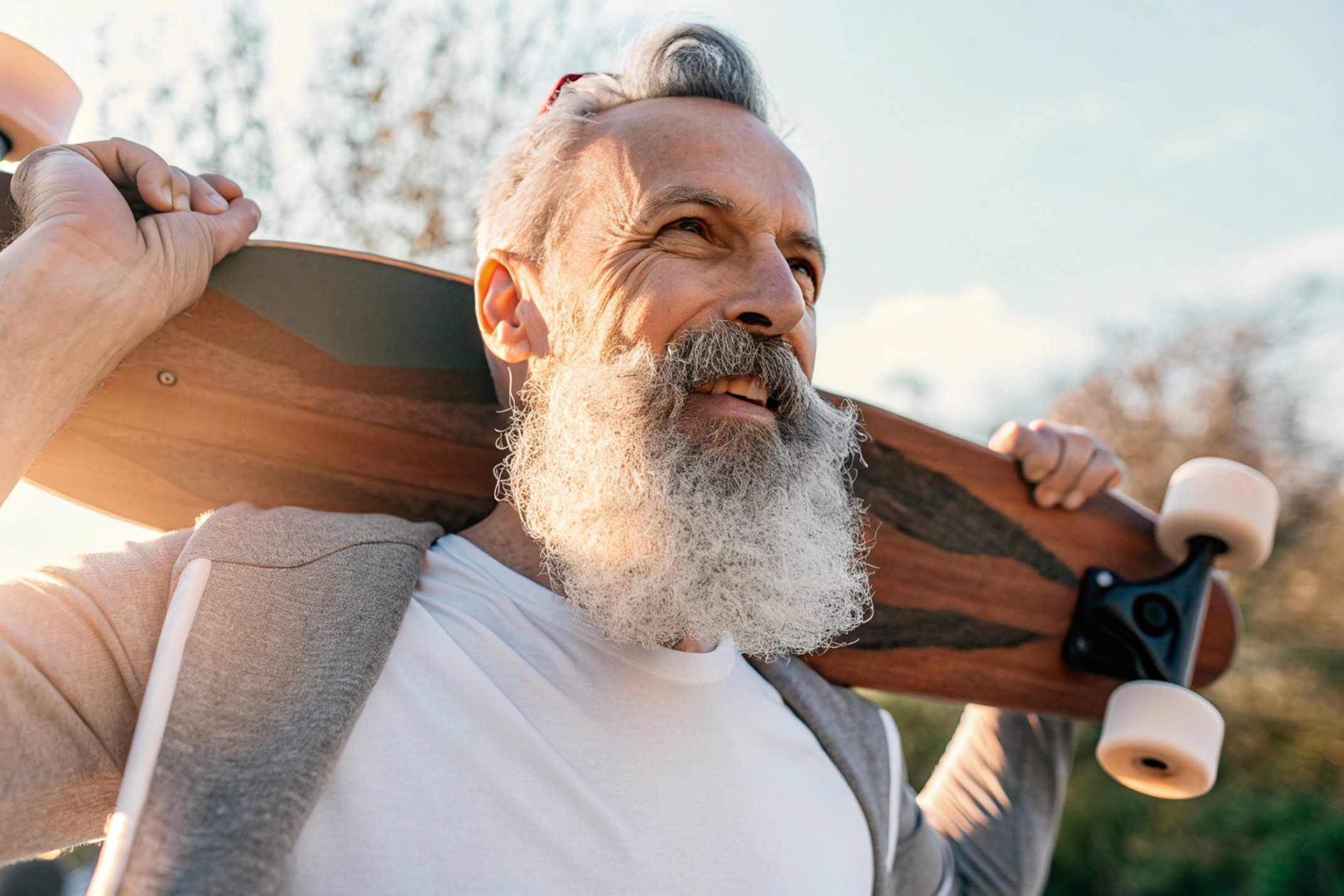 old man holding a skateboard