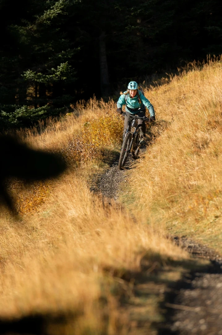one woman rides mountainbike towards camera