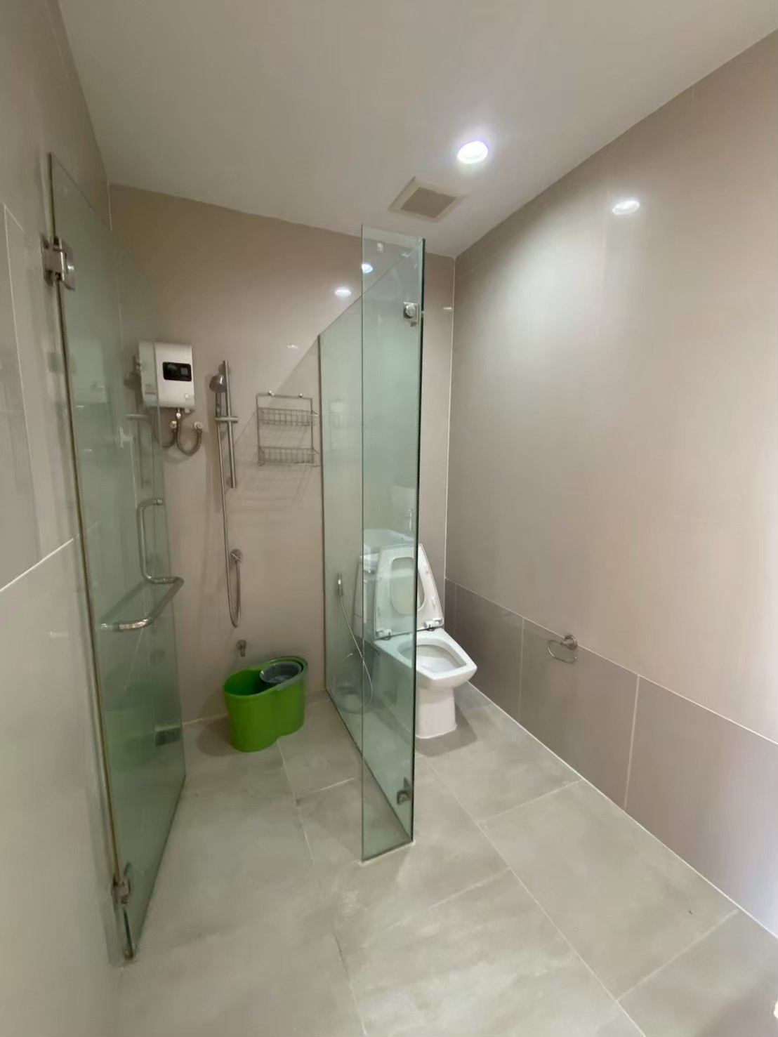 Spacious primary bathroom with dual vanities, black cabinetry, modern sconces, large windows with nature views, and elegant artwork