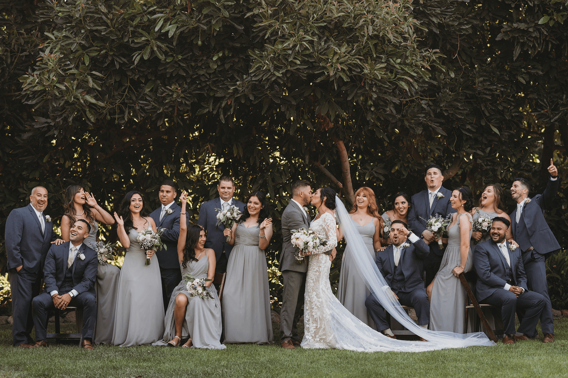 Editorial wedding party portrait with seated and standing poses