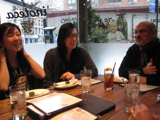 A photo of a group of people having dinner in a restaurant.