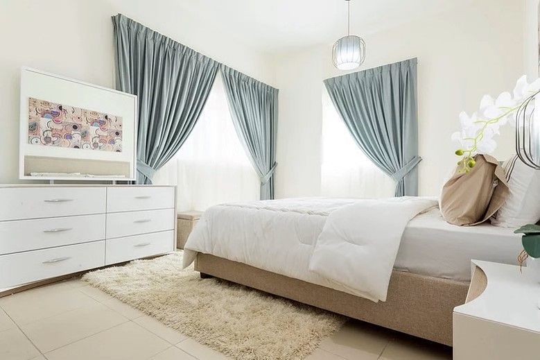 Bright and airy bedroom featuring contemporary design and plush decor. A cozy retreat at Ajman One Tower.