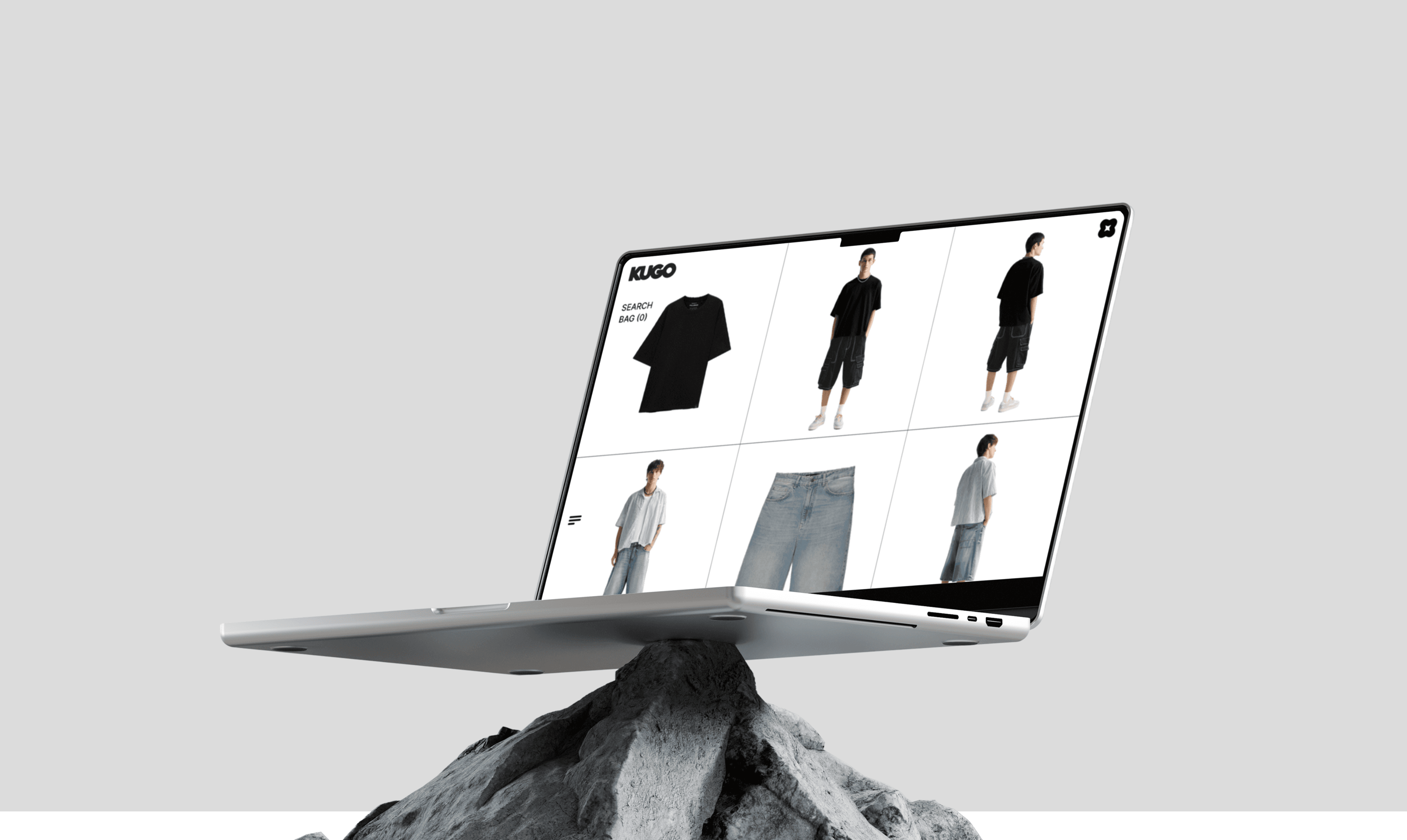 "Minimalist fashion e-commerce website displayed on a laptop balancing on a rock, showcasing stylish men's clothing in a modern grid layout."