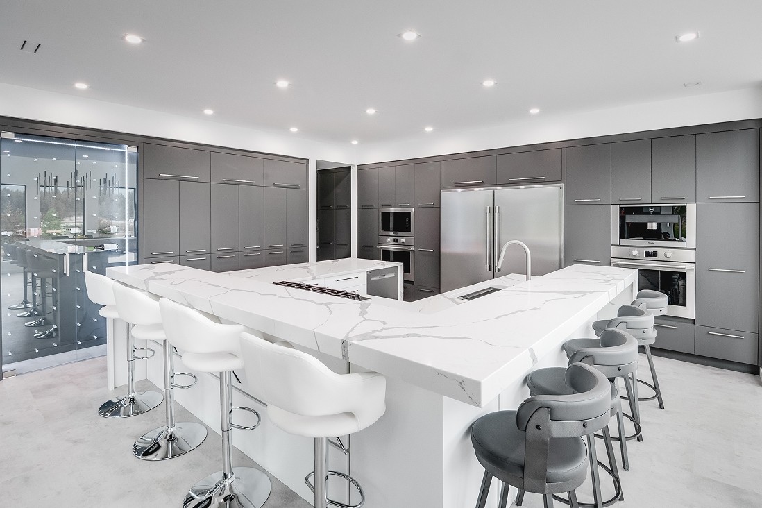 Full kitchen view with built-in appliances and open layout