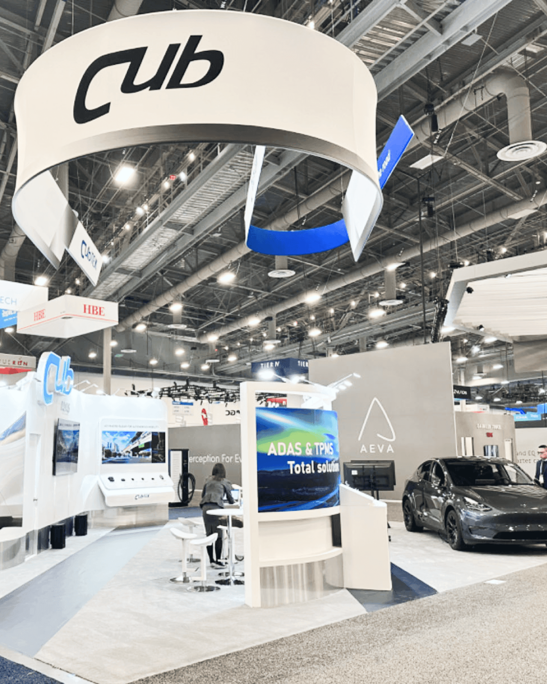 Large CES trade show booth overview with open layout, branded structure, and visitor-facing presentation space