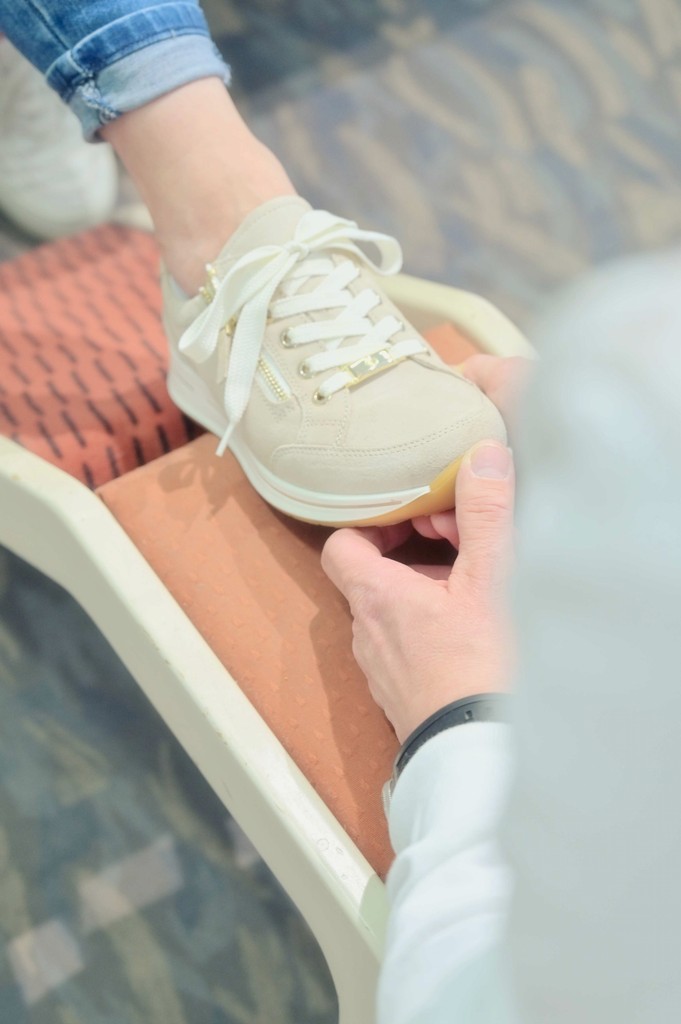 Ein Schuh bei der Anprobe am Fuß.