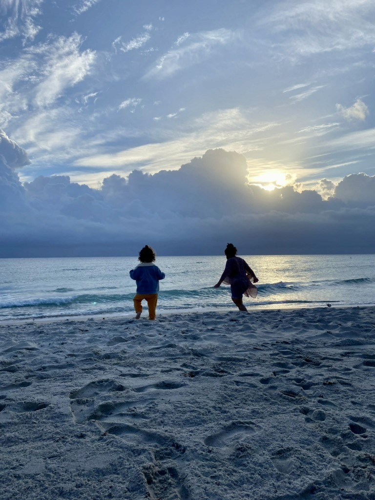 Sunset in Miami with a woman and a baby on the sand