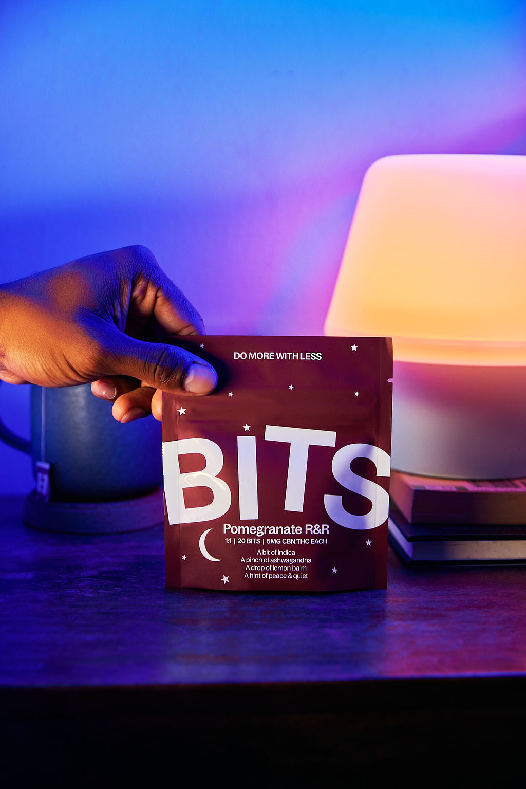 Woman posing by a gas station sign at night