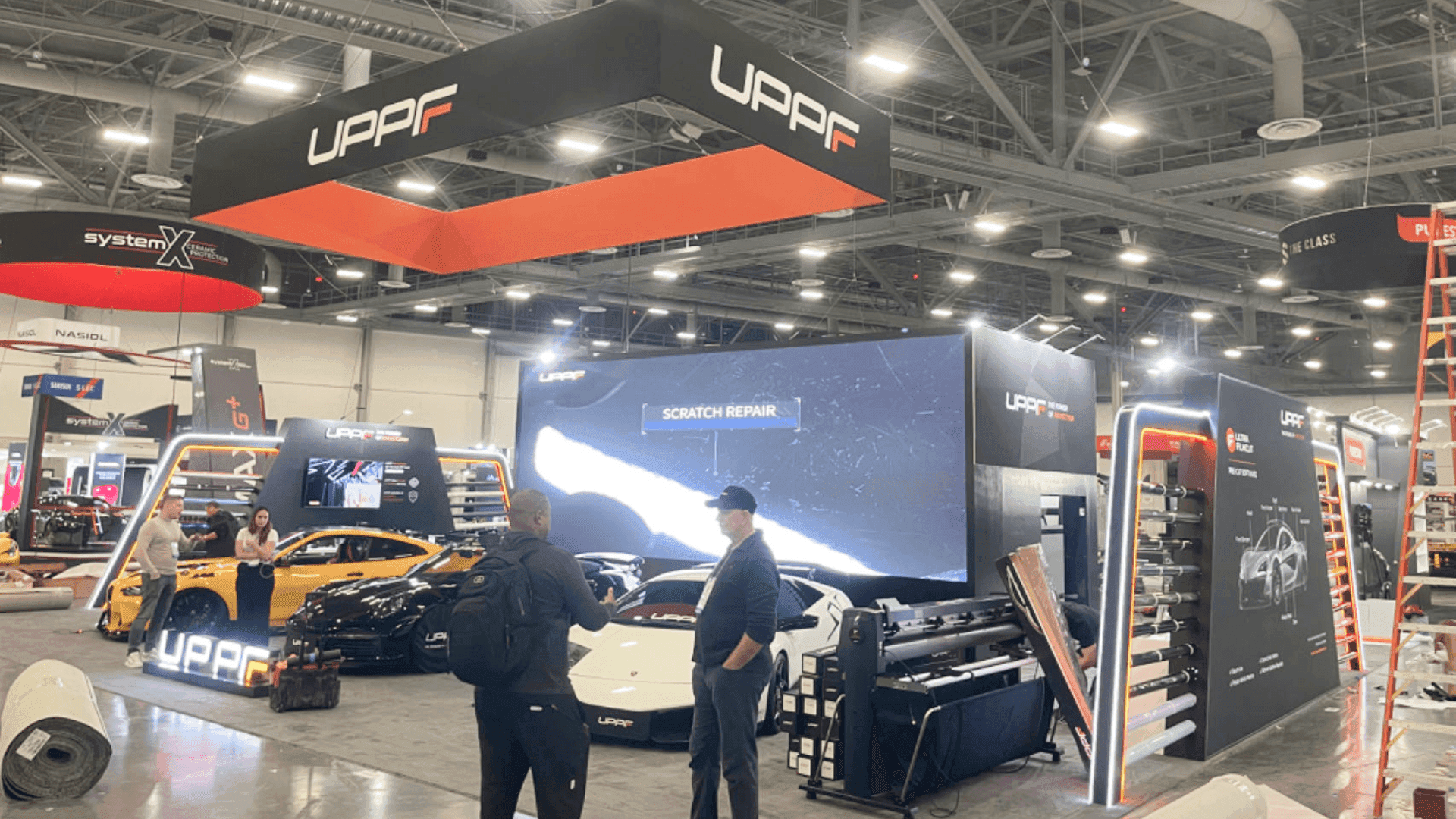 Charging and connected fleet solutions booth at Las Vegas Convention Center set with monitor-led presentation and compact meeting area for fleet discussions