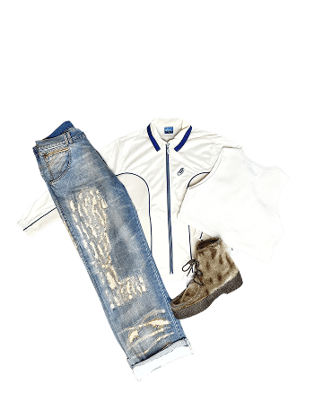 Arrangement of clothing: jeans, jacket, top, and boots on a black backdrop.