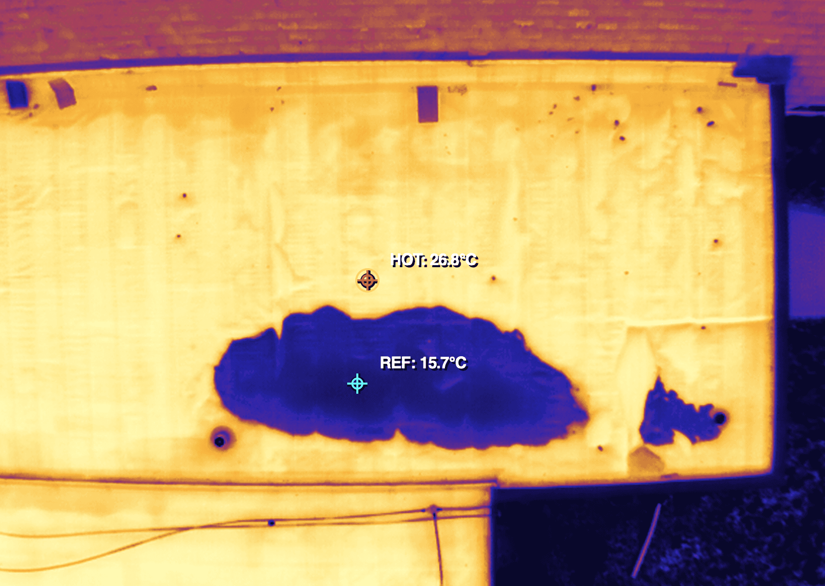 A thermal drone image showing potential water intrusion in a roof