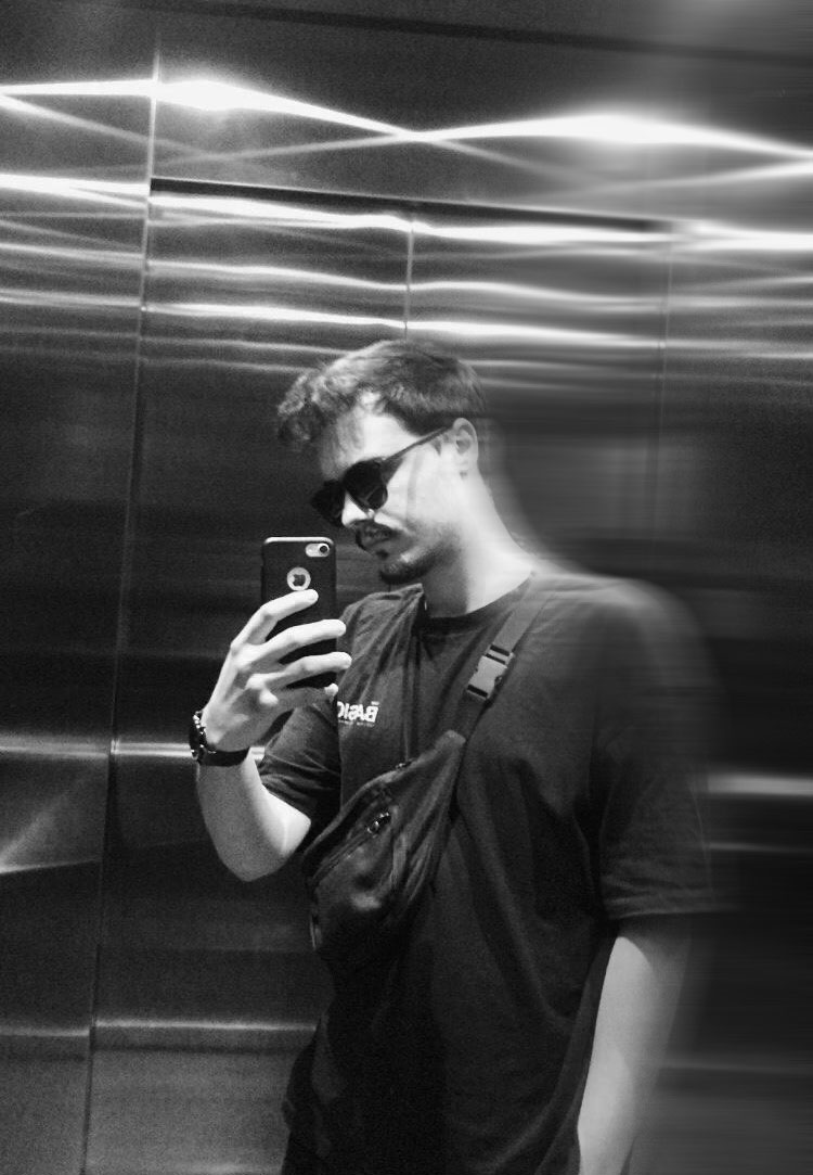 a blurry photo of a person standing in front of a wall