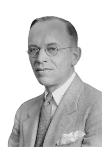 A black-and-white portrait of a middle-aged man wearing round glasses, a light-colored suit, and a patterned tie, with a pocket square visible. His composed expression and formal attire convey a sense of professionalism and sophistication, giving the image a classic and intellectual feel.