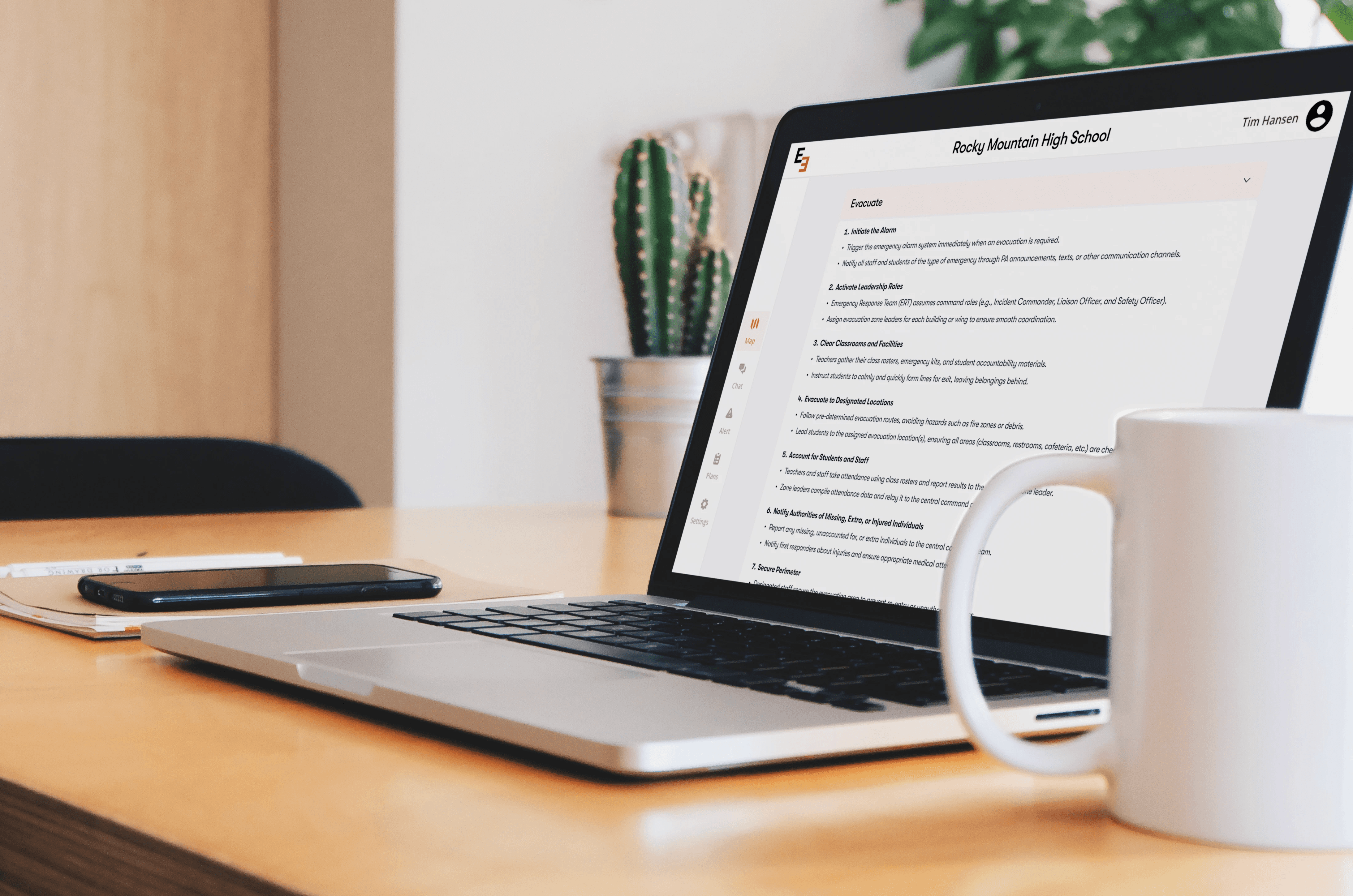 An image of a person using a laptop showing Emergent 3 software. It shows a schools emergency plan that each group must take in case of an emergency. Through Imapct Suite, schools and districts can aquire Emergent 3 software.