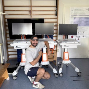 A volunteer celebrates completing three new GO Kart builds at a hospital in Germany.