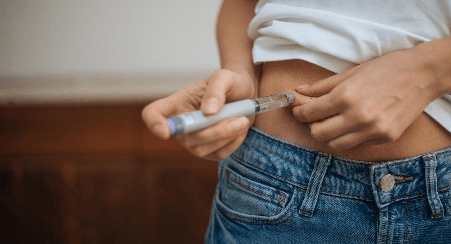 Woman injecting medication into her abdomen - Can I Ask My Doctor for Weight Loss Medication -