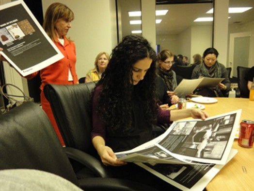 a woman looks at a large print