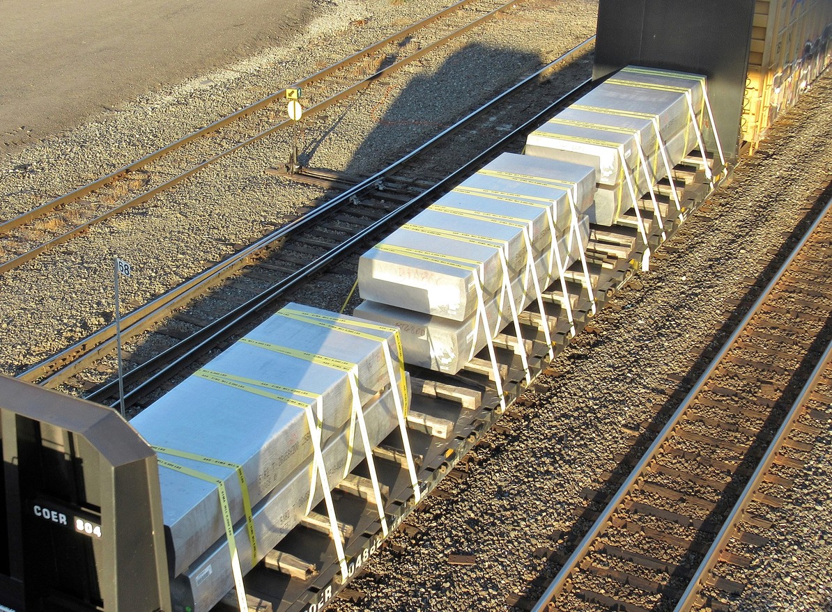 Rail freight with heavy concrete loads secured using dunnage and strapping to ensure load stability and safe transport