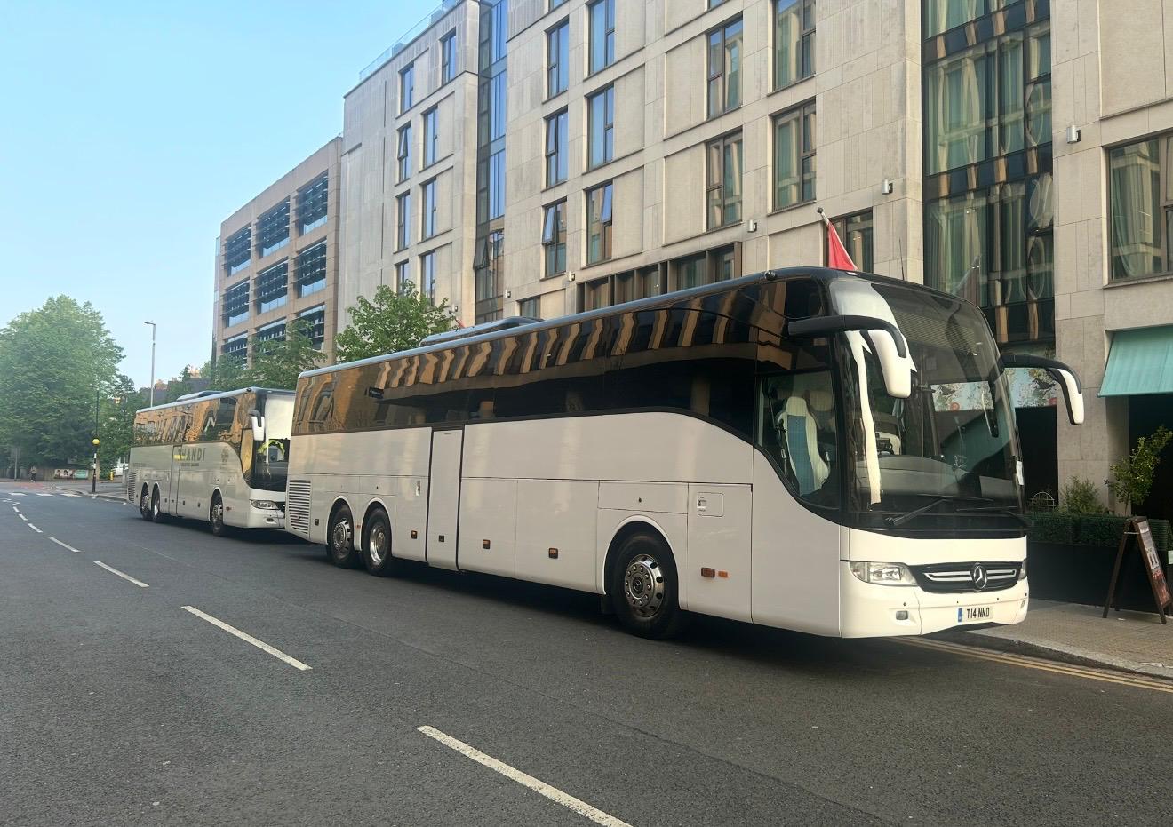 Luxury coach and minibus fleet used for city tours and private transfers, showcasing premium travel services and modern design in urban and scenic environments