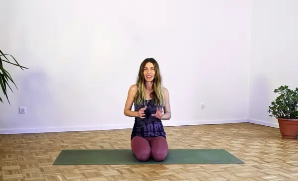 Woman in a seated meditation pose – postnatal yoga class to restore the pelvic floor through lateral rib breathing and Kegel exercises