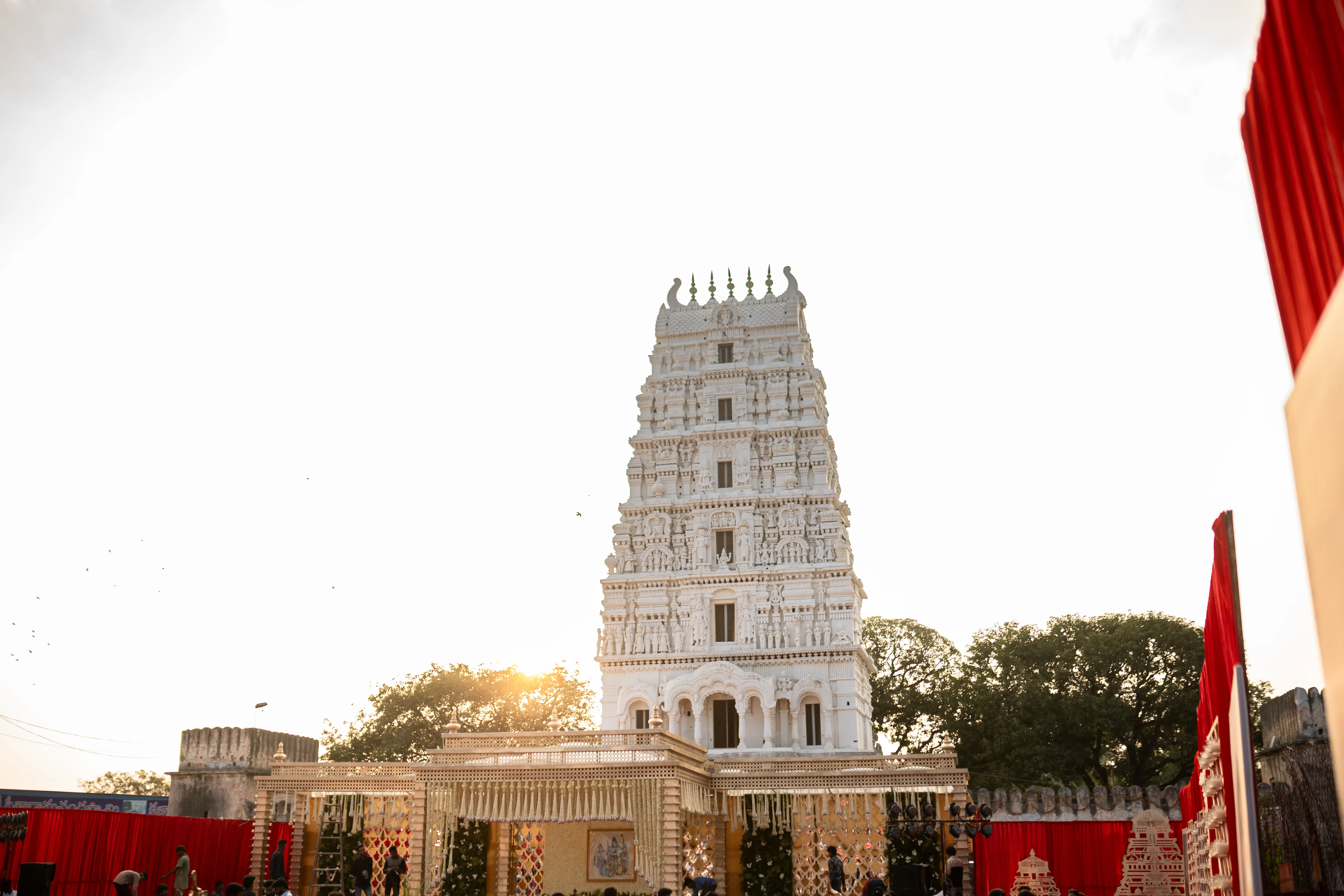 Stunning architectural shot of a South Indian temple tower at sunset, capturing intricate carvings and fine art details by Out of The Blues Fine Art Wedding Photography in Hyderabad