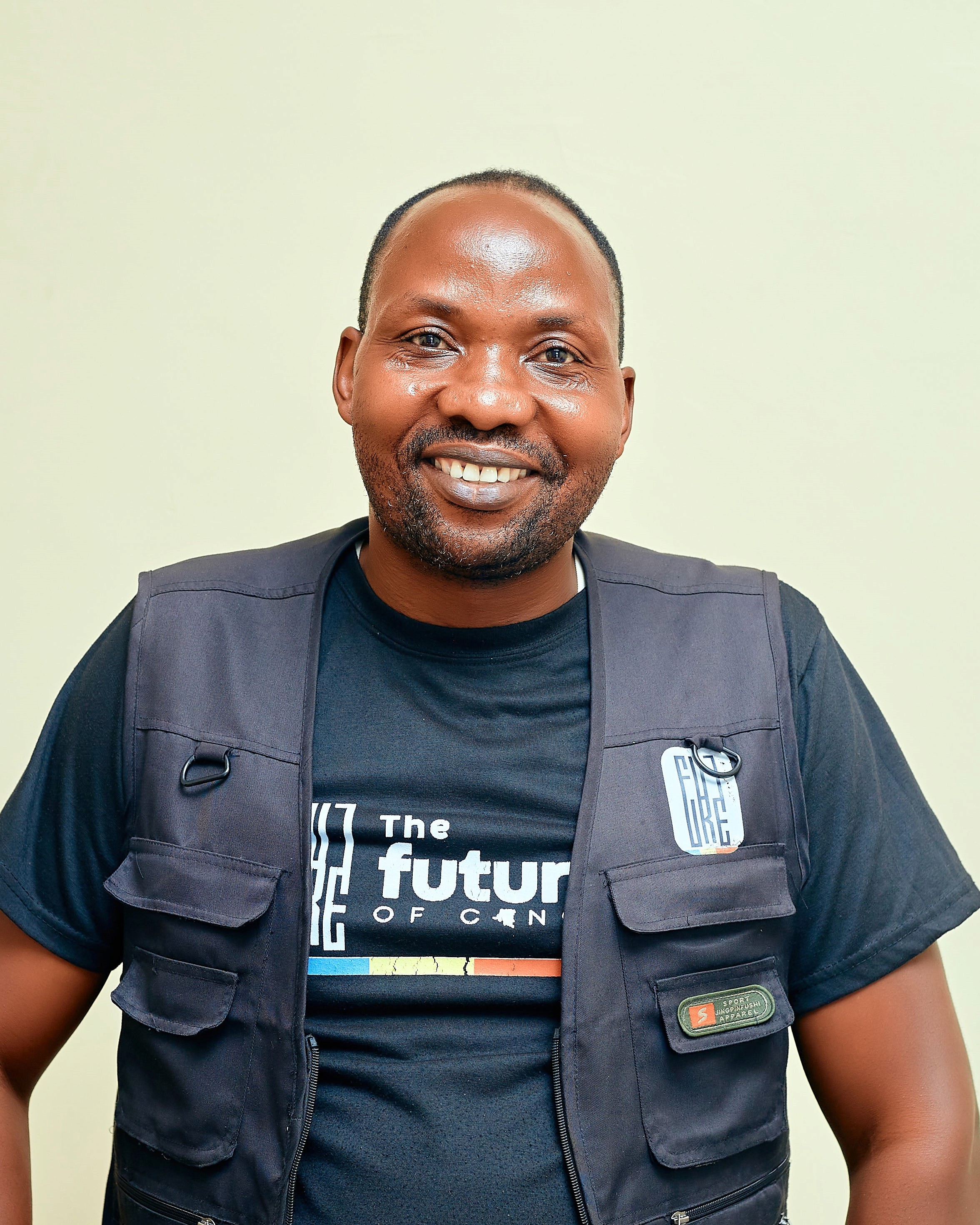 smiling man wearing black turtleneck shirt holding camrea