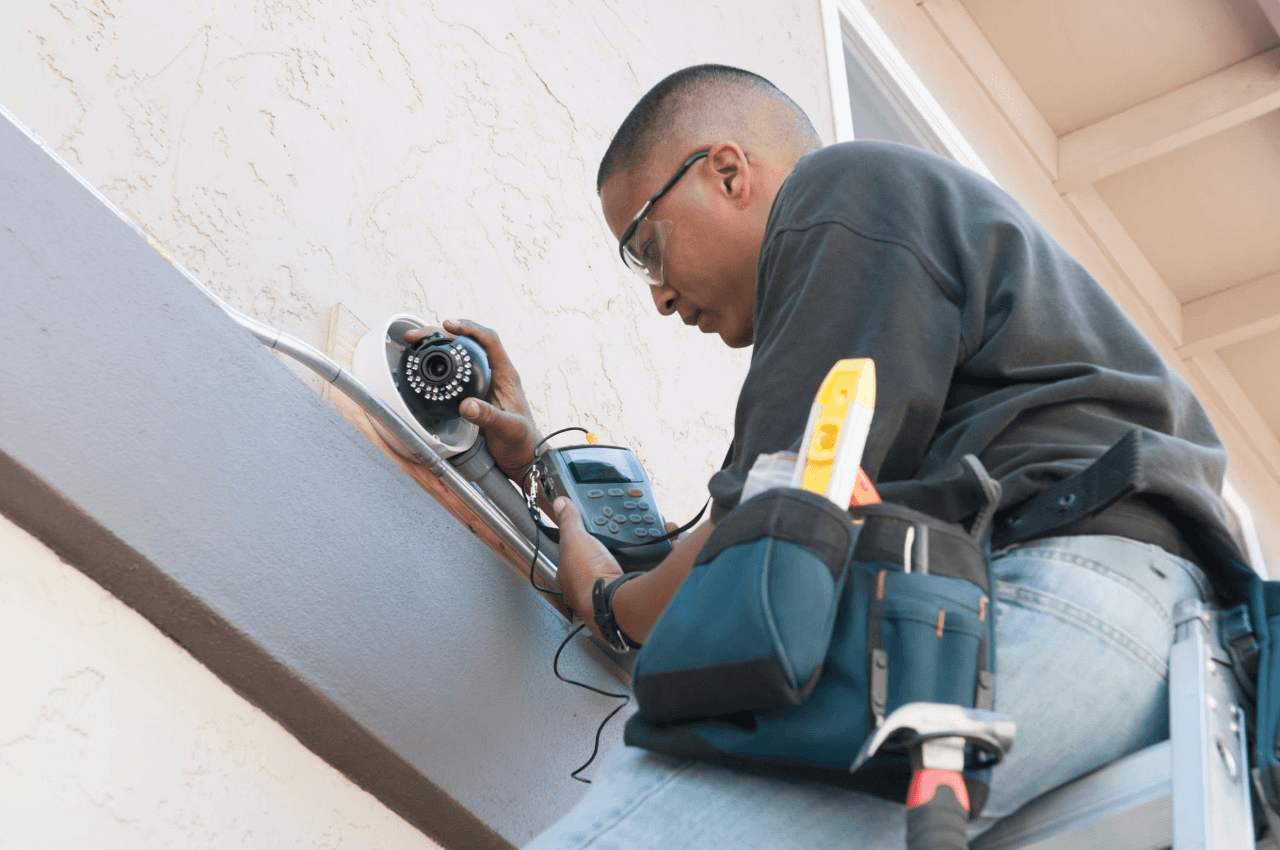 Electrician drilling in a wall