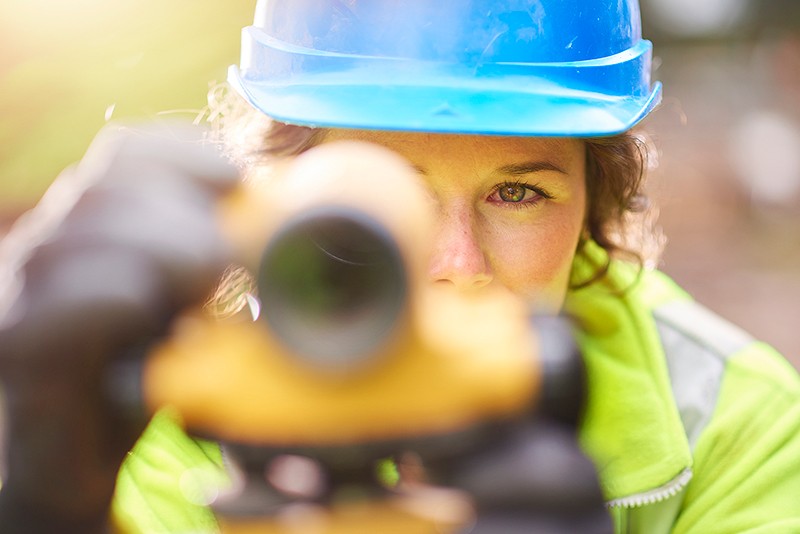 Female engineer with measuring device