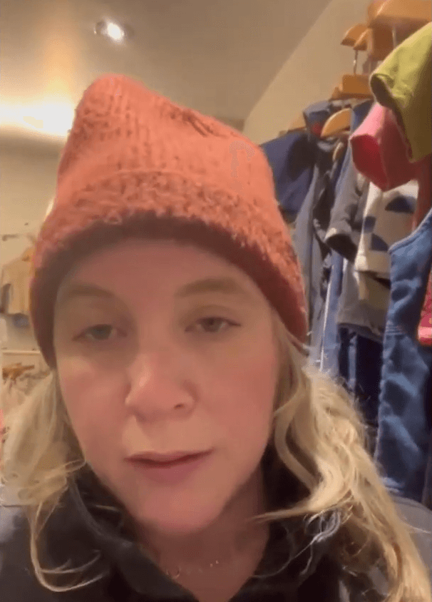 Close-up of lush, dark green leaves, some glossy and wet, against a muted background.