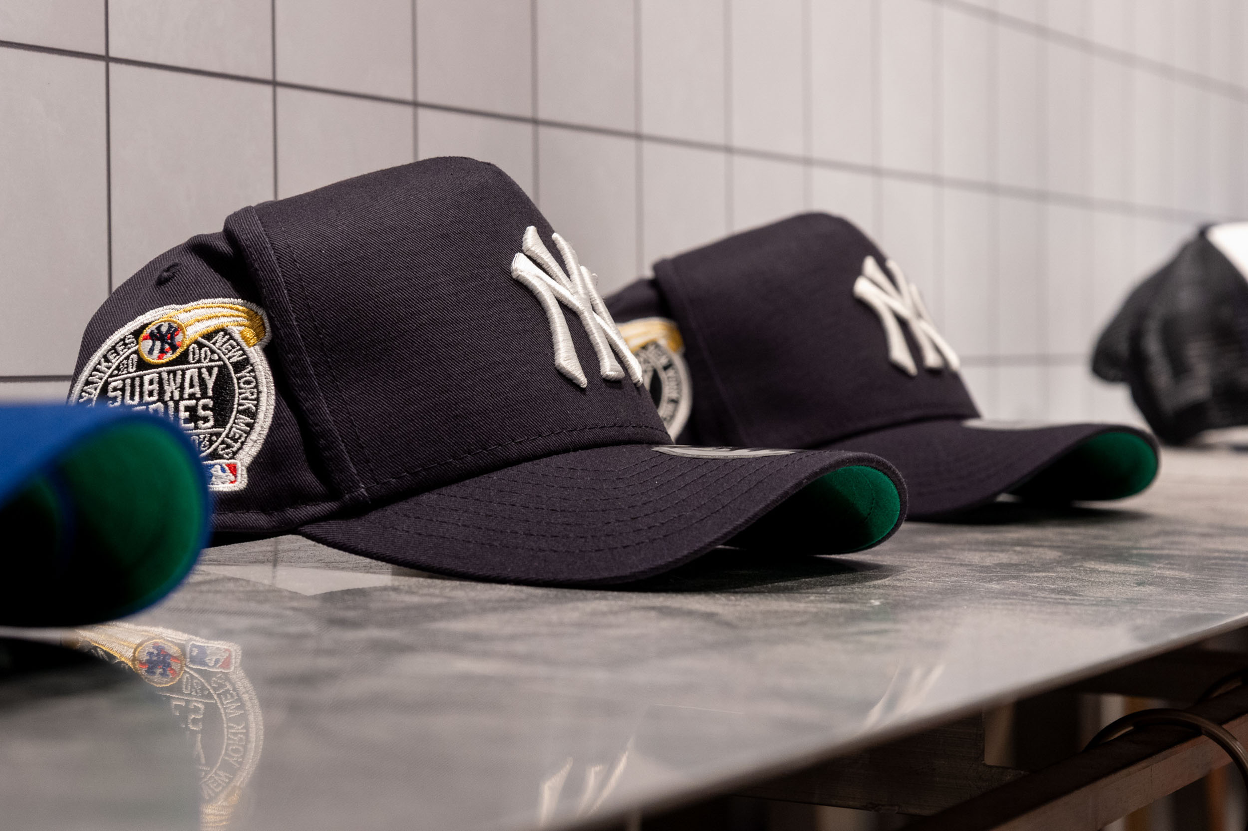 Branded cap display in a sports retail pop-up featuring product merchandising, lifestyle styling and experiential activation design