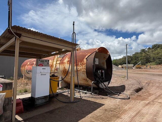 Smart looking Compac petrol dispenser and payment terminal installed at a remote airport, with a small plane visible on the tarmac in the background.