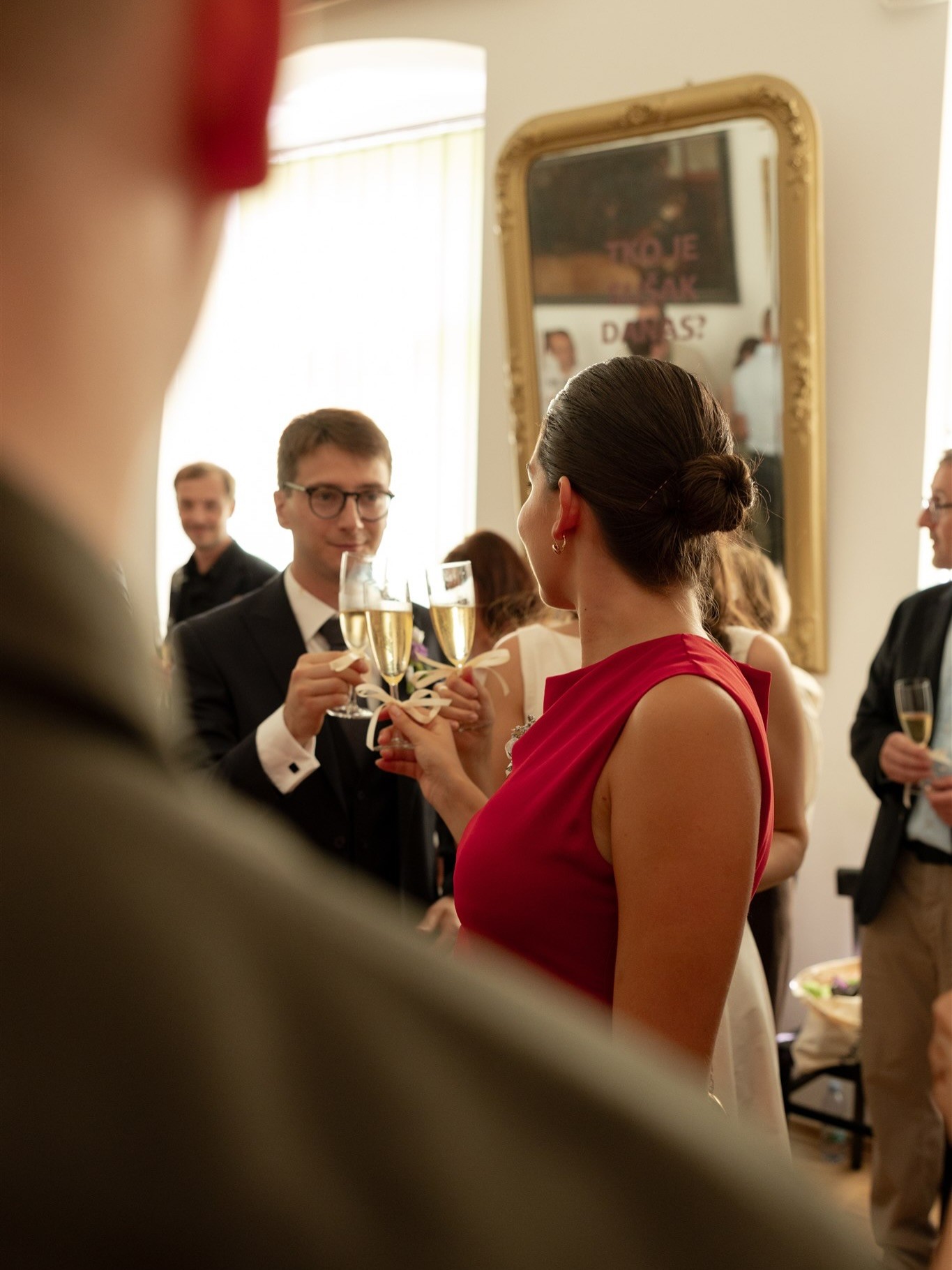 Groom doing cheers with a guest a t a wedding