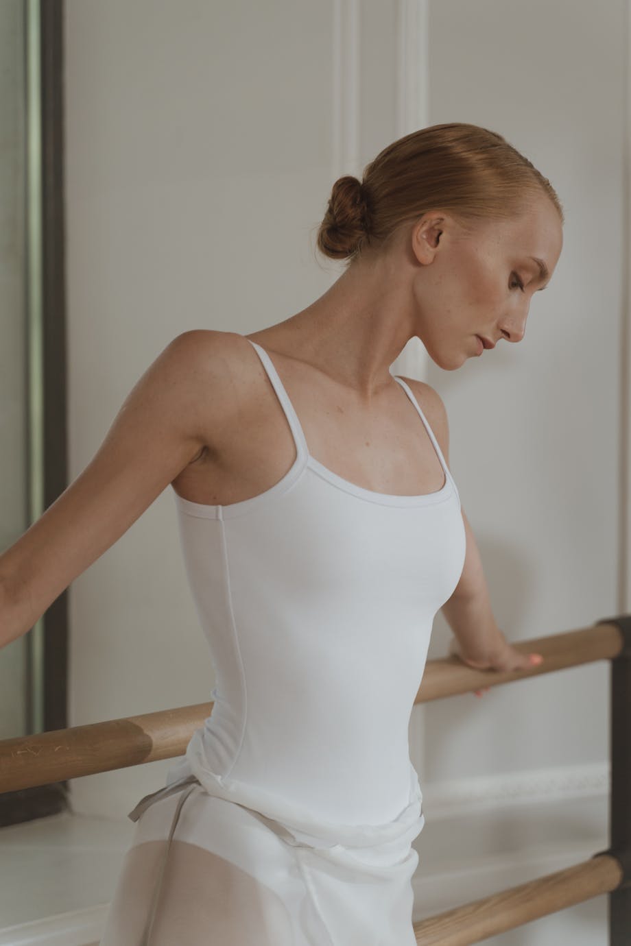 Ballet dancer holding the training bar