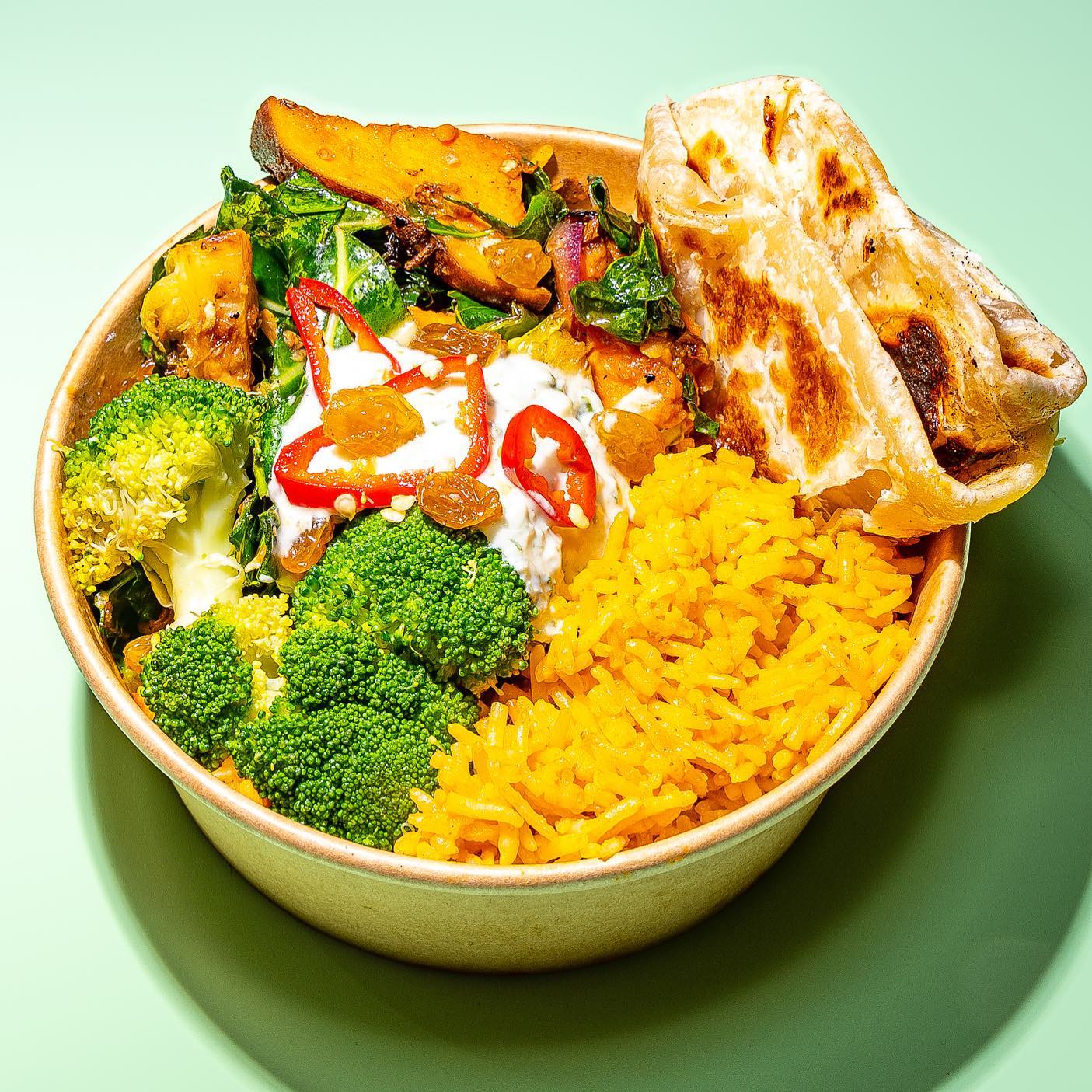 Vibrant jollof rice bowl topped with perfectly roasted chicken, fresh vegetables, and house-made sauce. A bold, West African-inspired dish from FIELDTRIP.