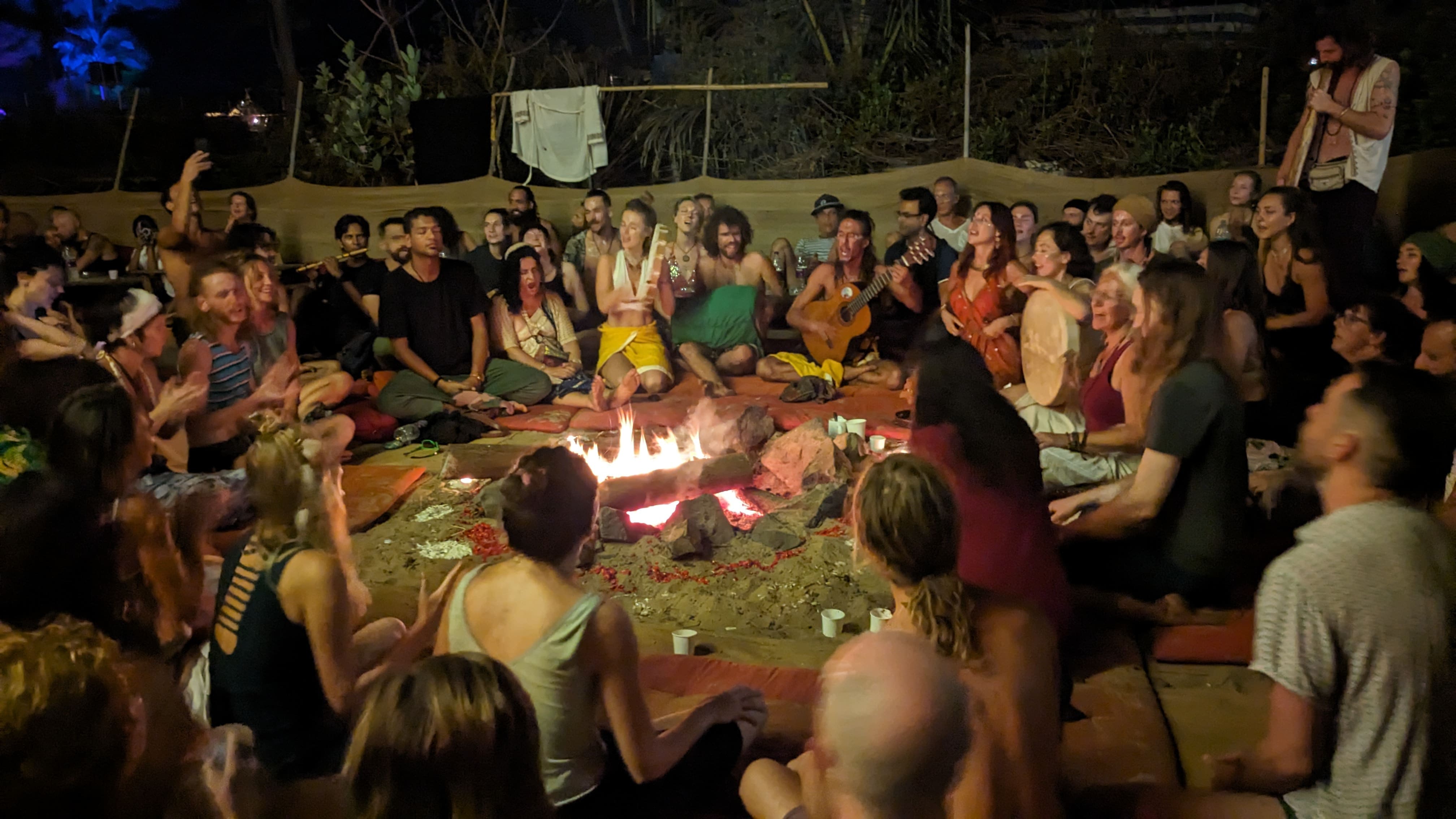 Meeting of people around the fire to sing and play together