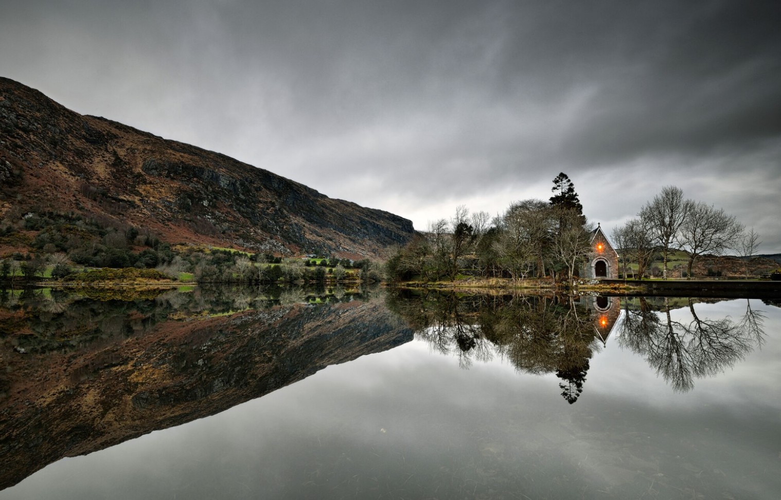 a couple of people standing on top of a mountain
