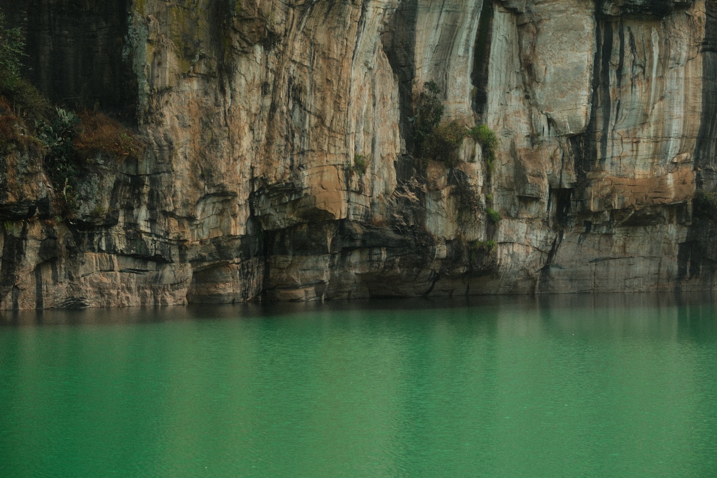 The still green water of Lake Otjikoto, a sinkhole lake in northern Namibia