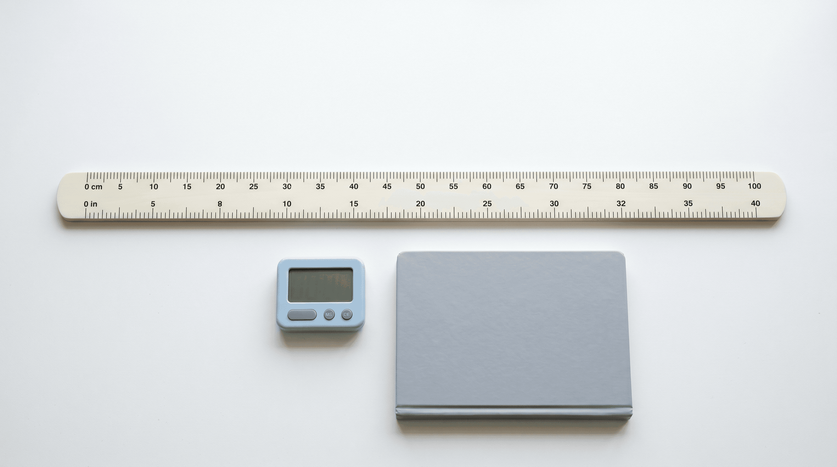 Pediatric growth chart ruler beside a small timer