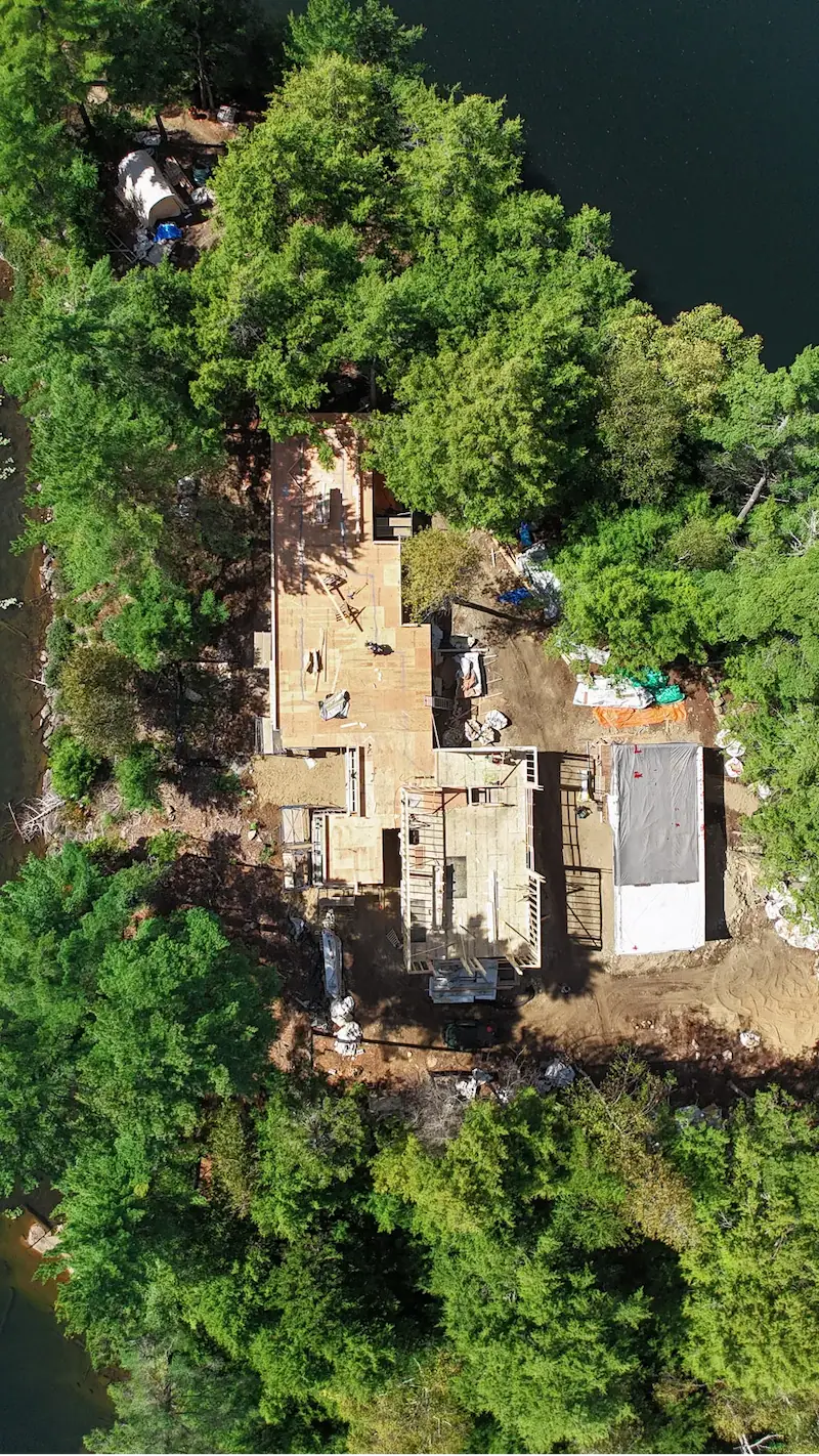 Rockaway lake cottage underconstruction on an island surrounded by woods and water.
