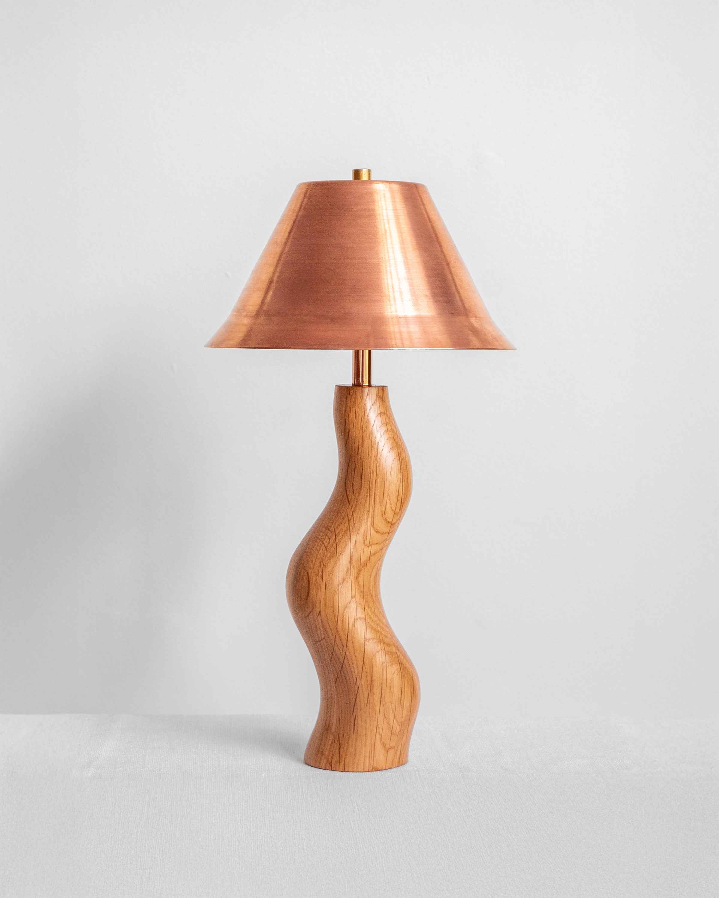 Dancing Desk Lamp with Oak base and Copper shade on a light grey background with UK, EU and US/CA wiring available Wilkinson & Rivera