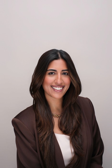 corporate headshot of brown skinned busineses woman