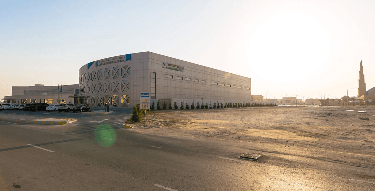 A large building with a spacious parking lot in Mohammed Bin Zayed City.