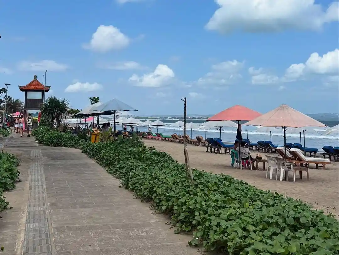 Scenic beachfront walk near Seminyak, a prime location for luxury coastal real estate investment.