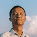 Man's headshot against blue sky