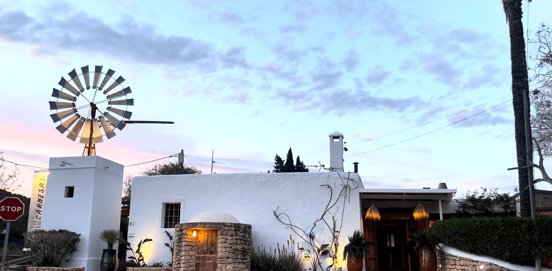 Exterior of Carnesa Churrascaria Brasiliana with windmill, a stylish Ibiza dining experience.