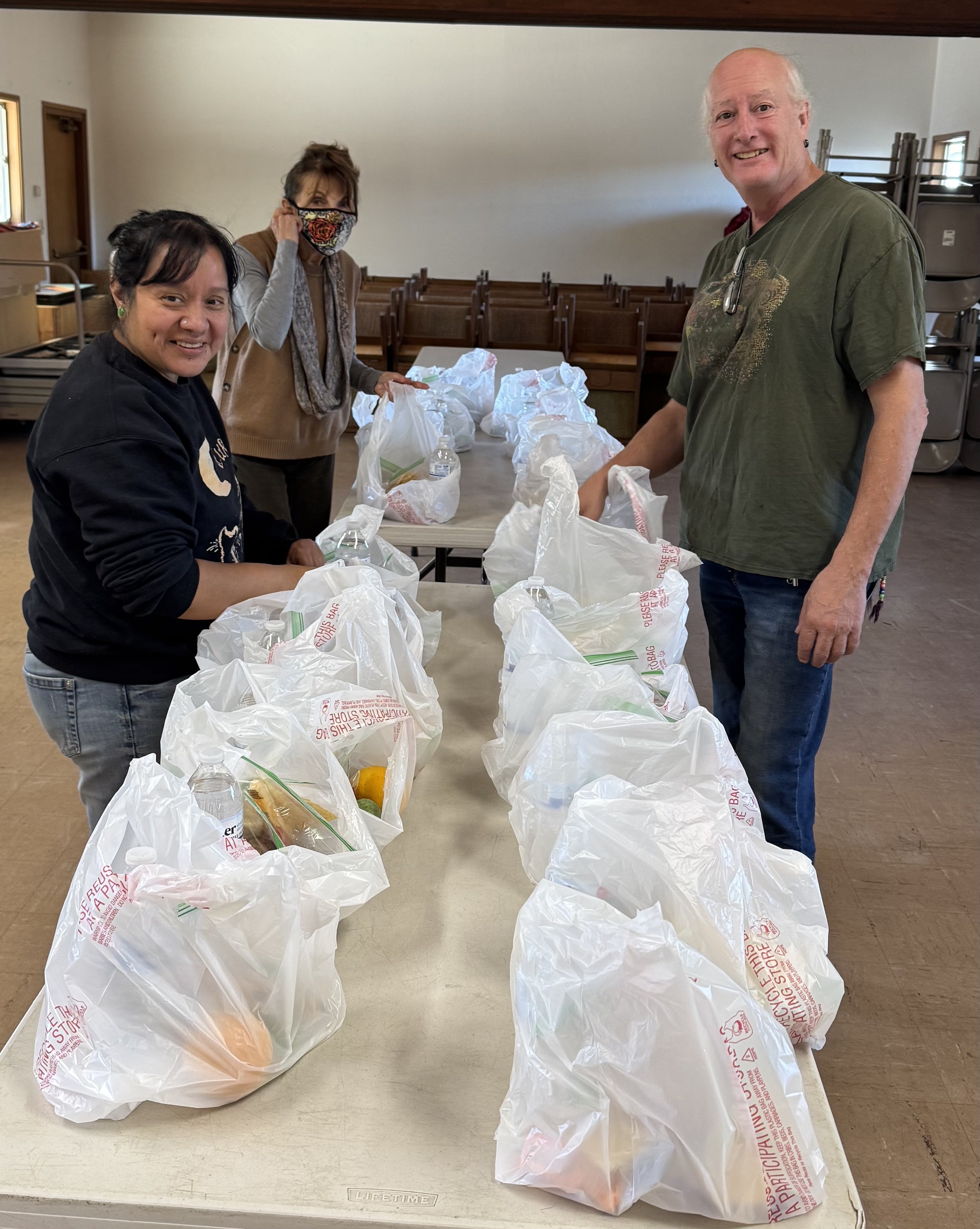 Volunteers preparing and packing food together