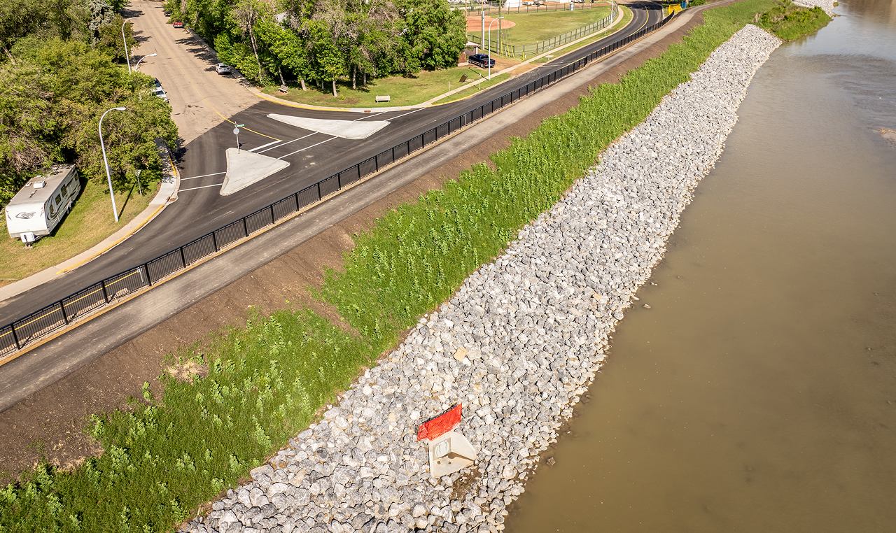 Overhead view of Redi-Rock retaining wall, asphalt pathway, and riprap armoring at Drumheller downtown dike